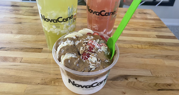 A spread of NovaCane cups and a bowl on a wood table.